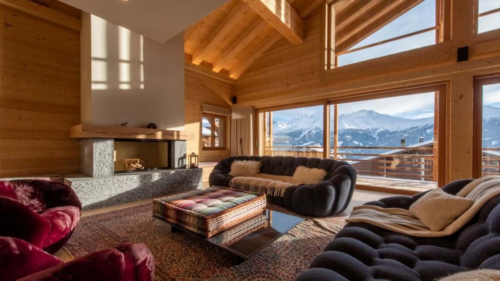 Living area with wood-burning fireplace and panoramic alpine views