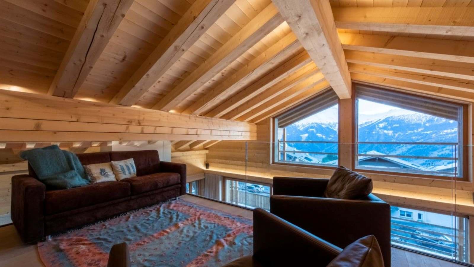 Mezzanine lounge with mountain views and vaulted timber ceilings