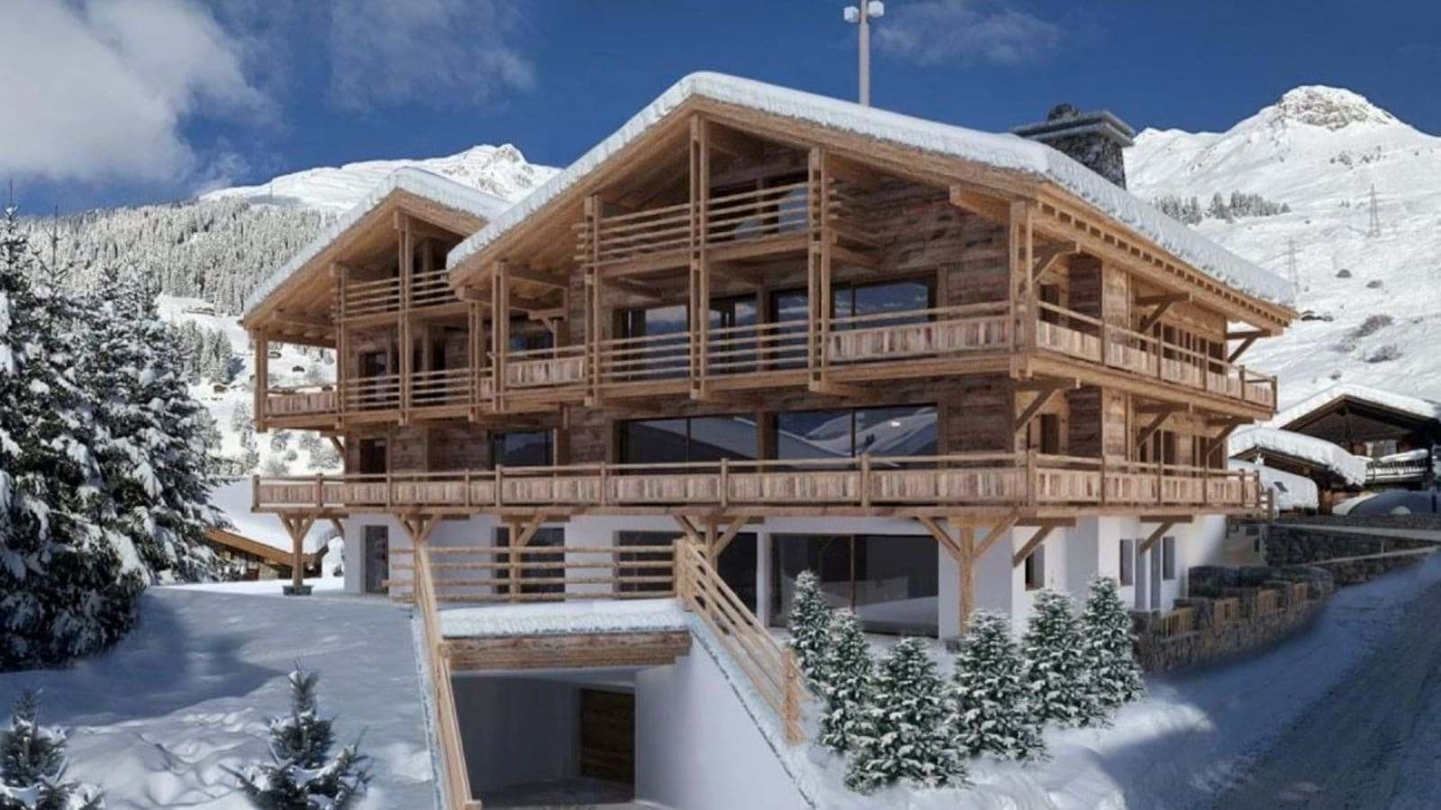 Ski-in chalet exterior with wraparound balconies and underground garage access