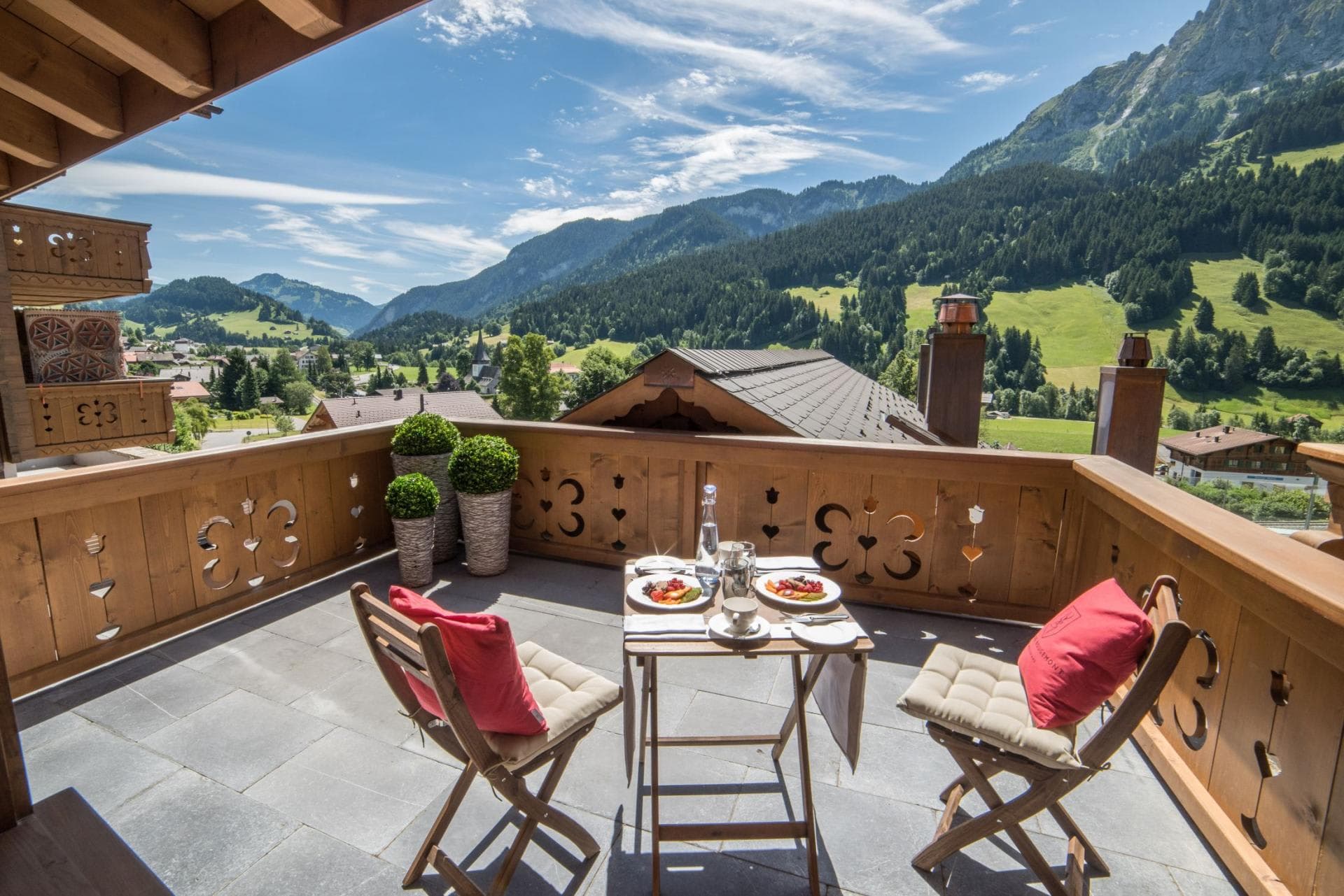 Private balcony with bistro seating and panoramic views of the French Alps