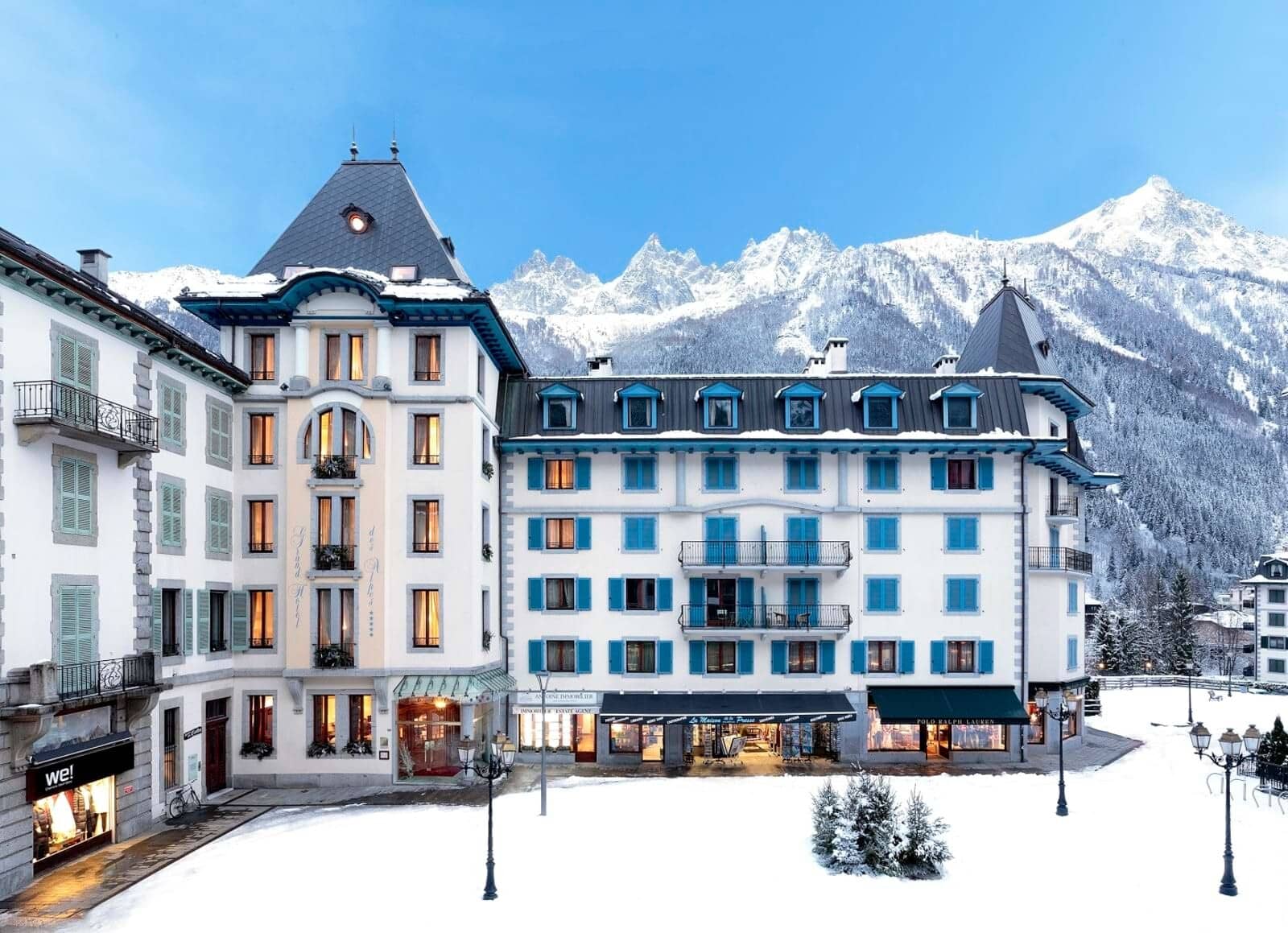 Chalet exterior with ground-floor boutique shops and Mont Blanc mountain backdrop