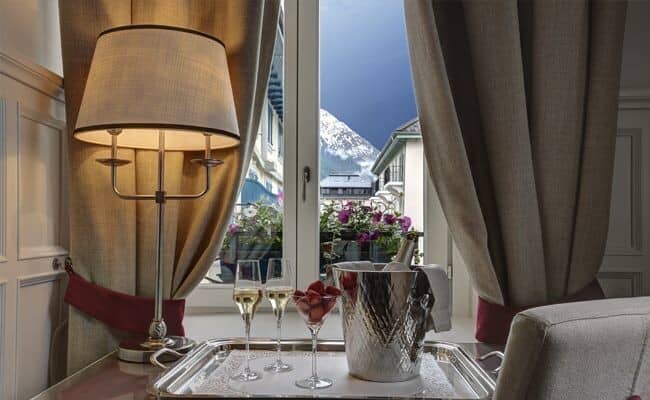 Guest suite window view of snow-capped mountains and village