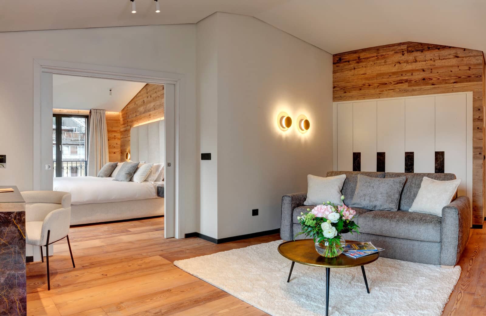 Living area with sofa bed and adjacent bedroom via pocket door