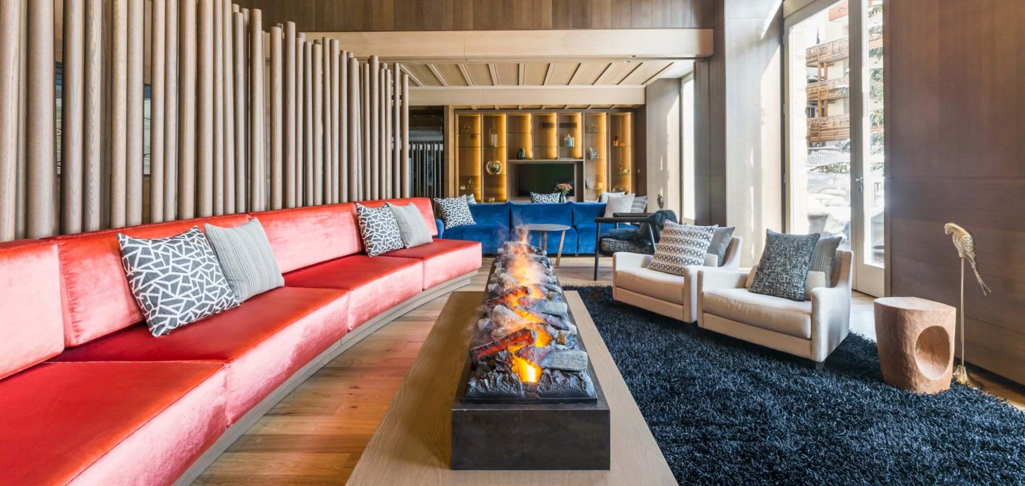 Lounge with vapor fireplace, integrated wood paneling, and ample plush seating