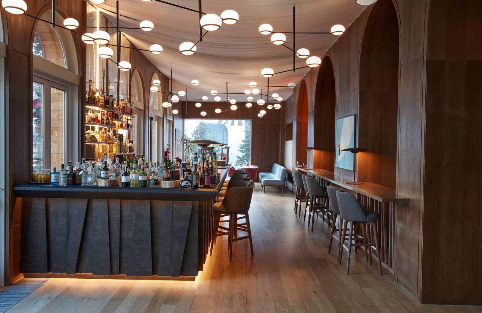 Full-service cocktail bar with stool seating and secondary laptop-friendly counter