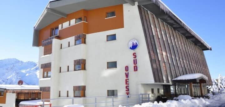 Ski-in apartment building with mountain views and covered entrance