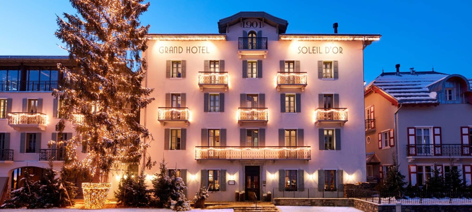 Historic hotel facade established in 1901 with private balconies