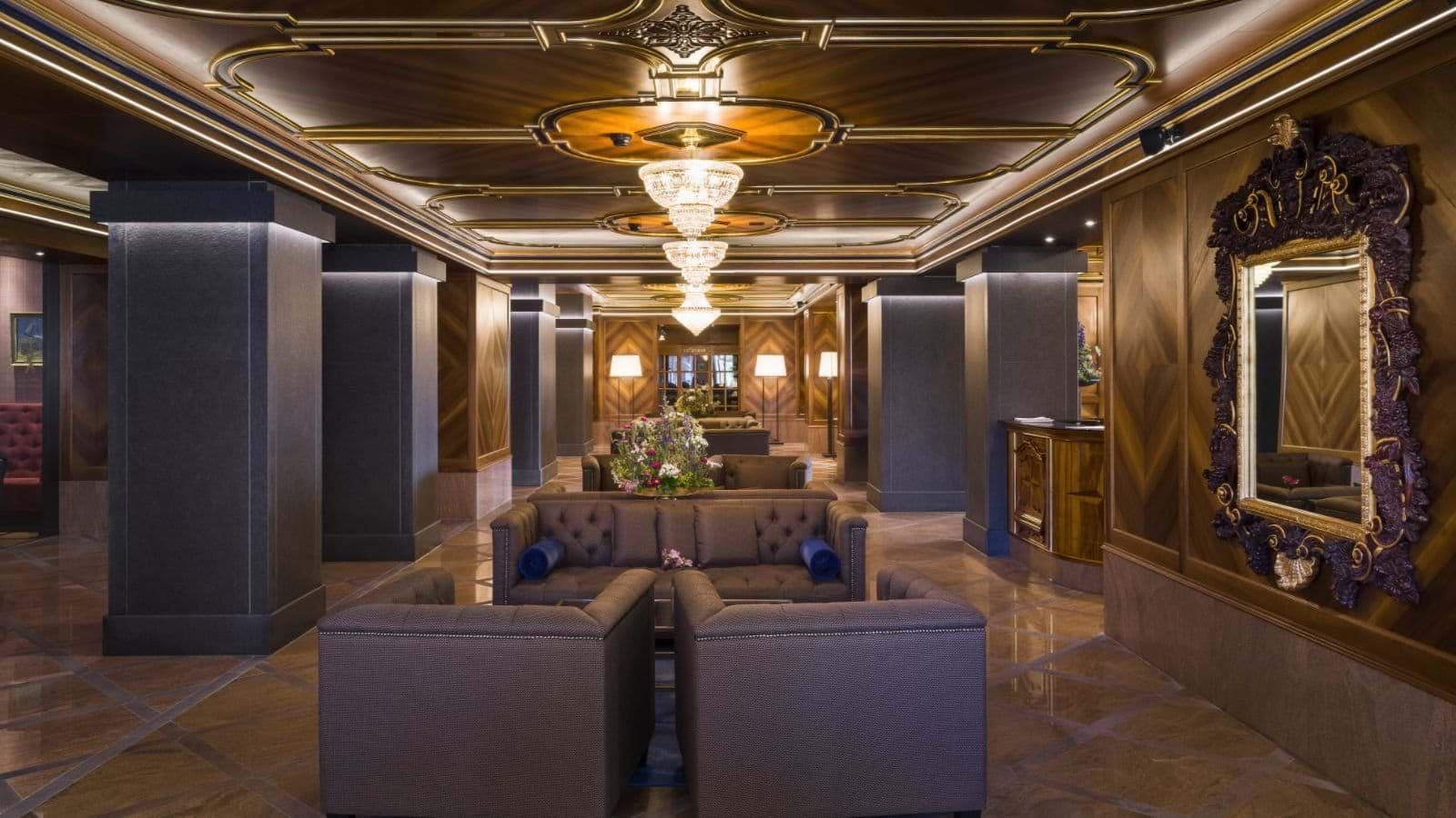Building lobby with lounge seating and coffered wood ceiling