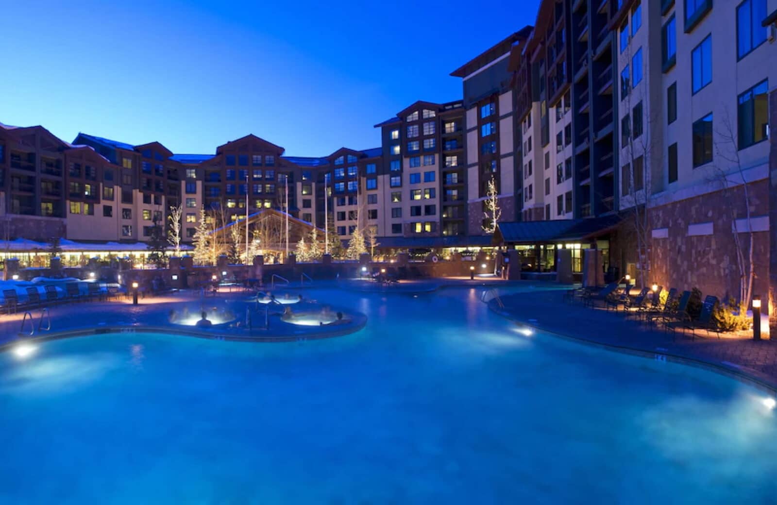 Heated outdoor pool and hot tubs with mountain resort views