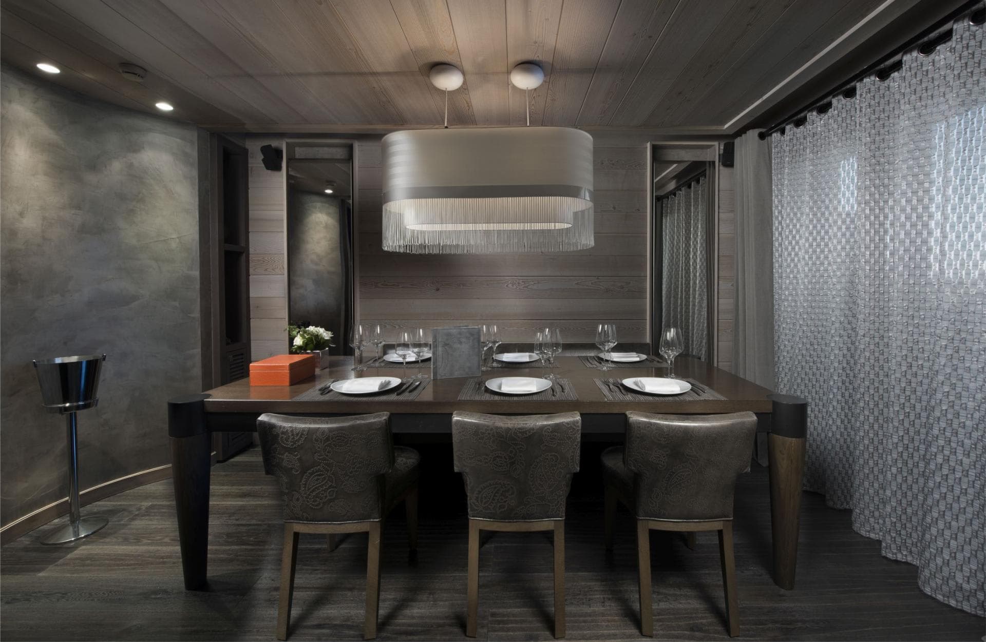 Dining room with wood-paneled walls and seating for 6