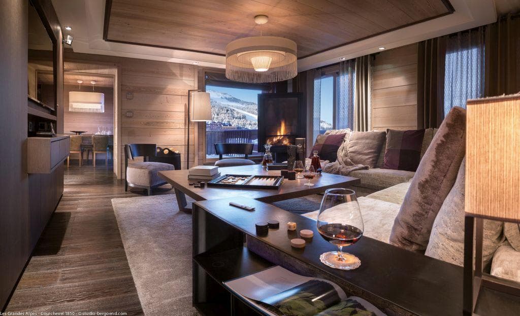 Living room with wood-burning fireplace and ski slope views
