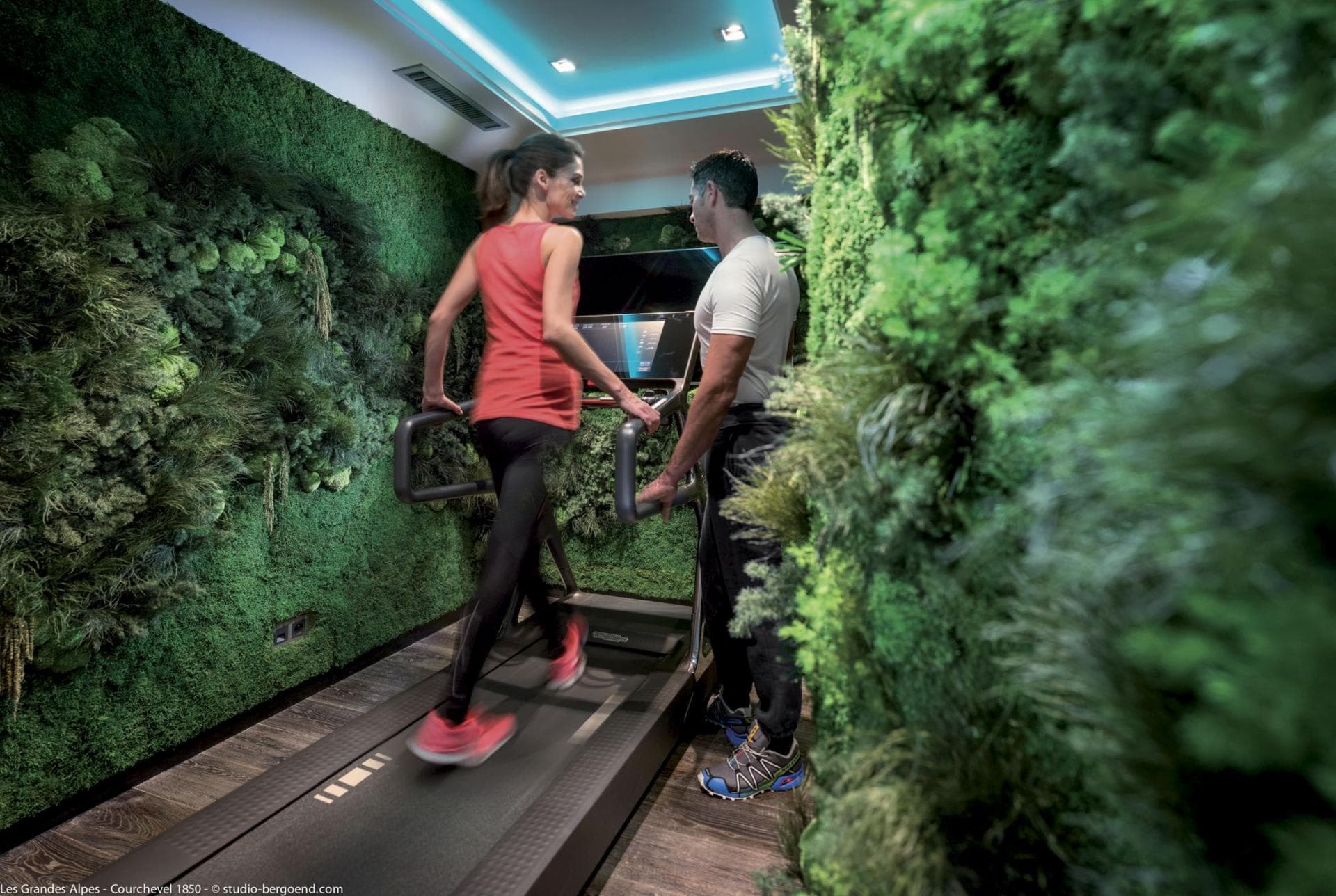 Fitness area with Technogym treadmill and living moss walls
