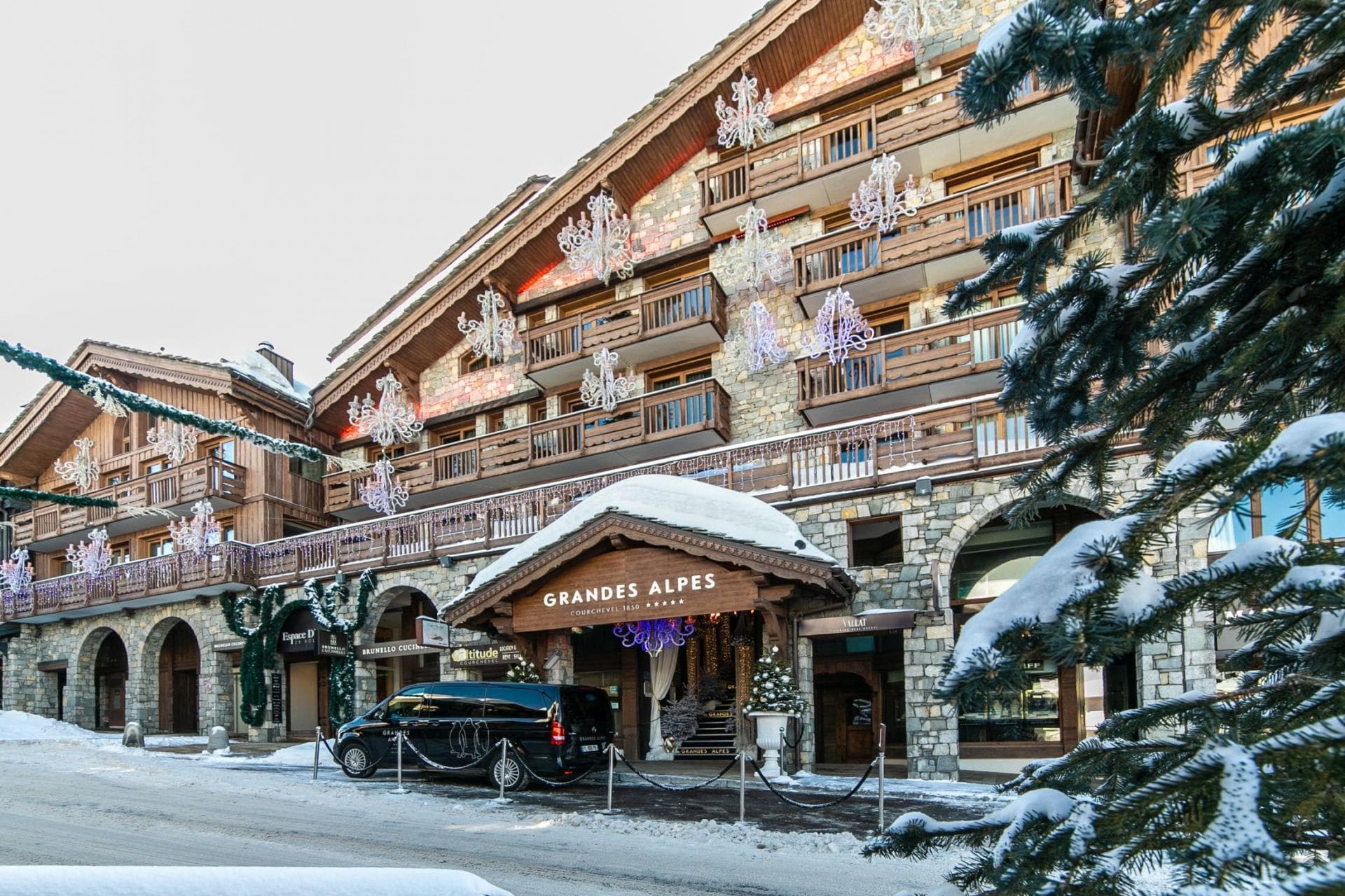 Ski-in, ski-out hotel exterior with stone facades and private balconies