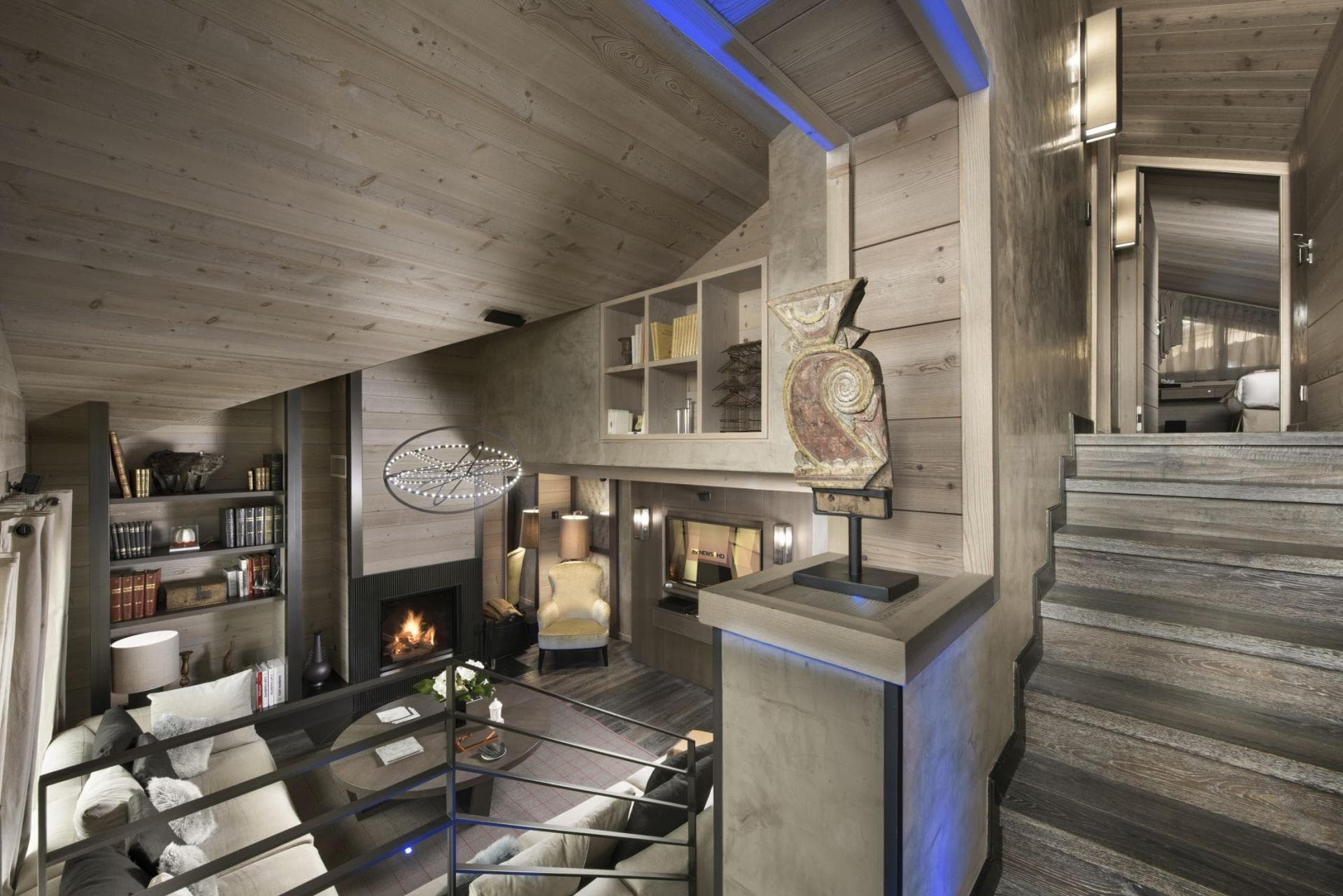 Split-level living area featuring wood-burning fireplace and built-in shelving