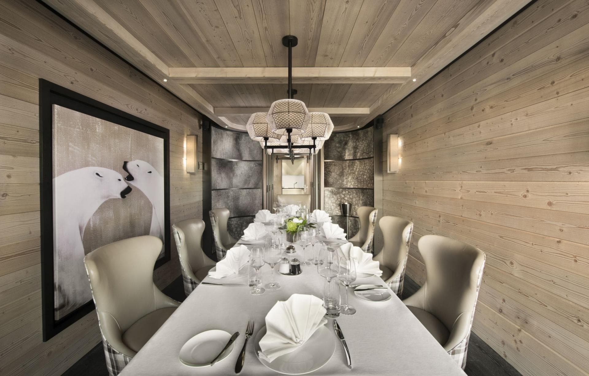 Formal dining room with seating for 10; wood-paneled walls and ceiling