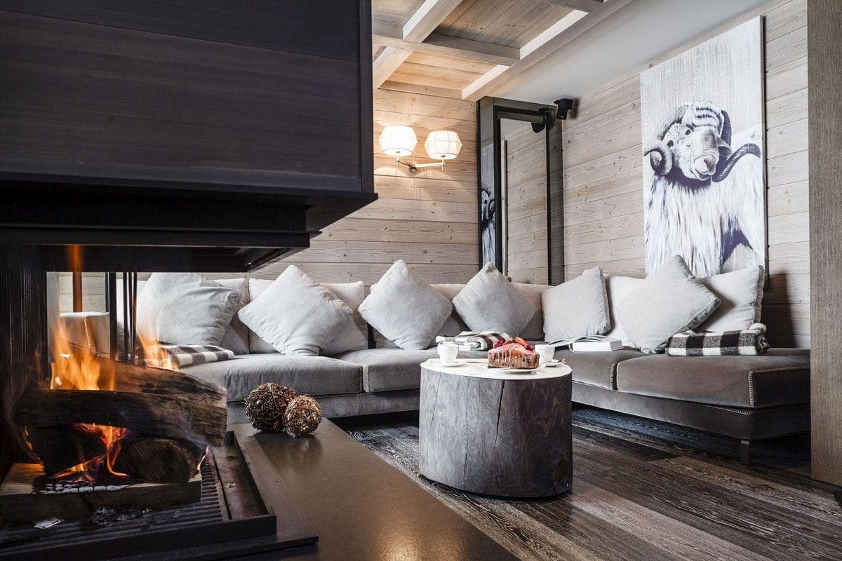 Living area with wood-burning fireplace and velvet sectional seating