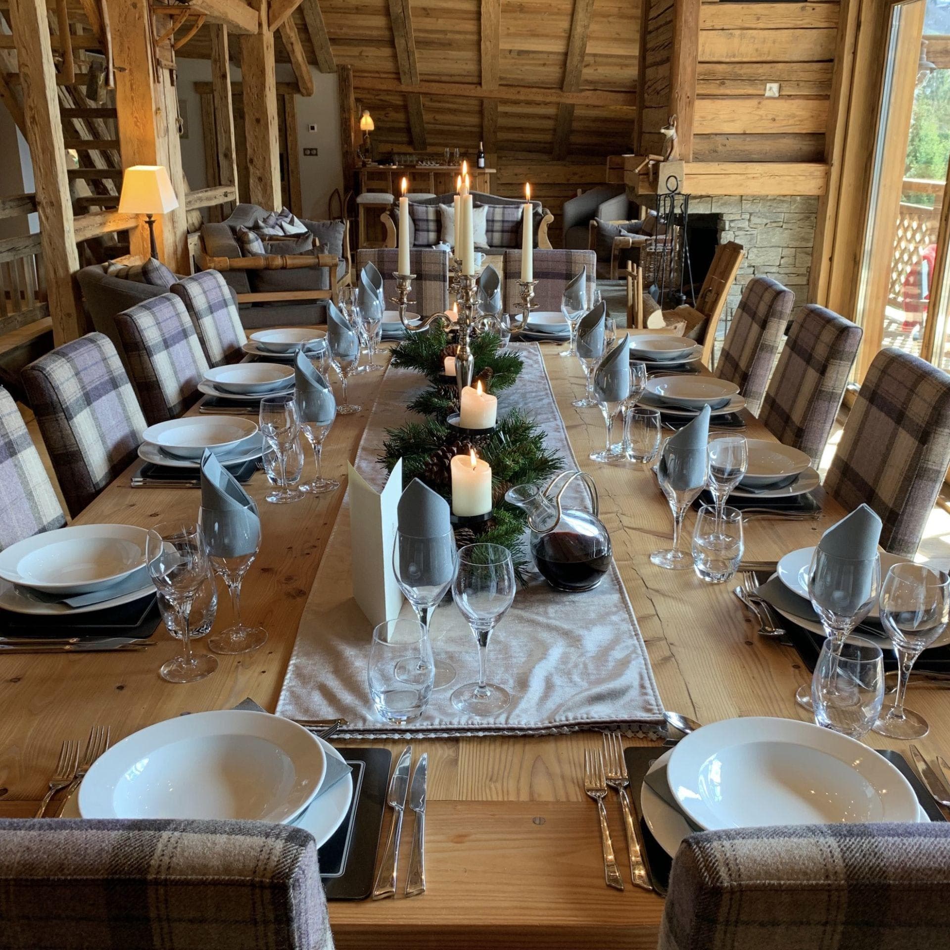 Large dining table seats 12; adjacent to living area with stone fireplace