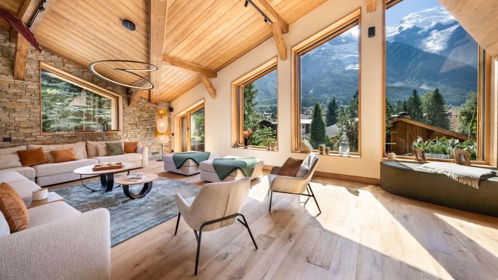 Living room with vaulted ceilings and floor-to-ceiling mountain views