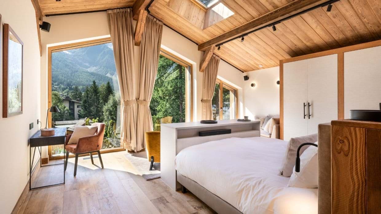 Bedroom with king bed, skylight, and mountain views