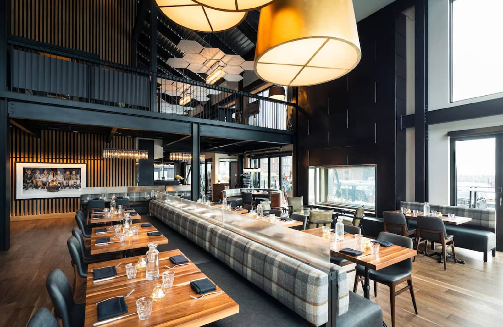 Industrial dining room with mezzanine level and double-height ceilings