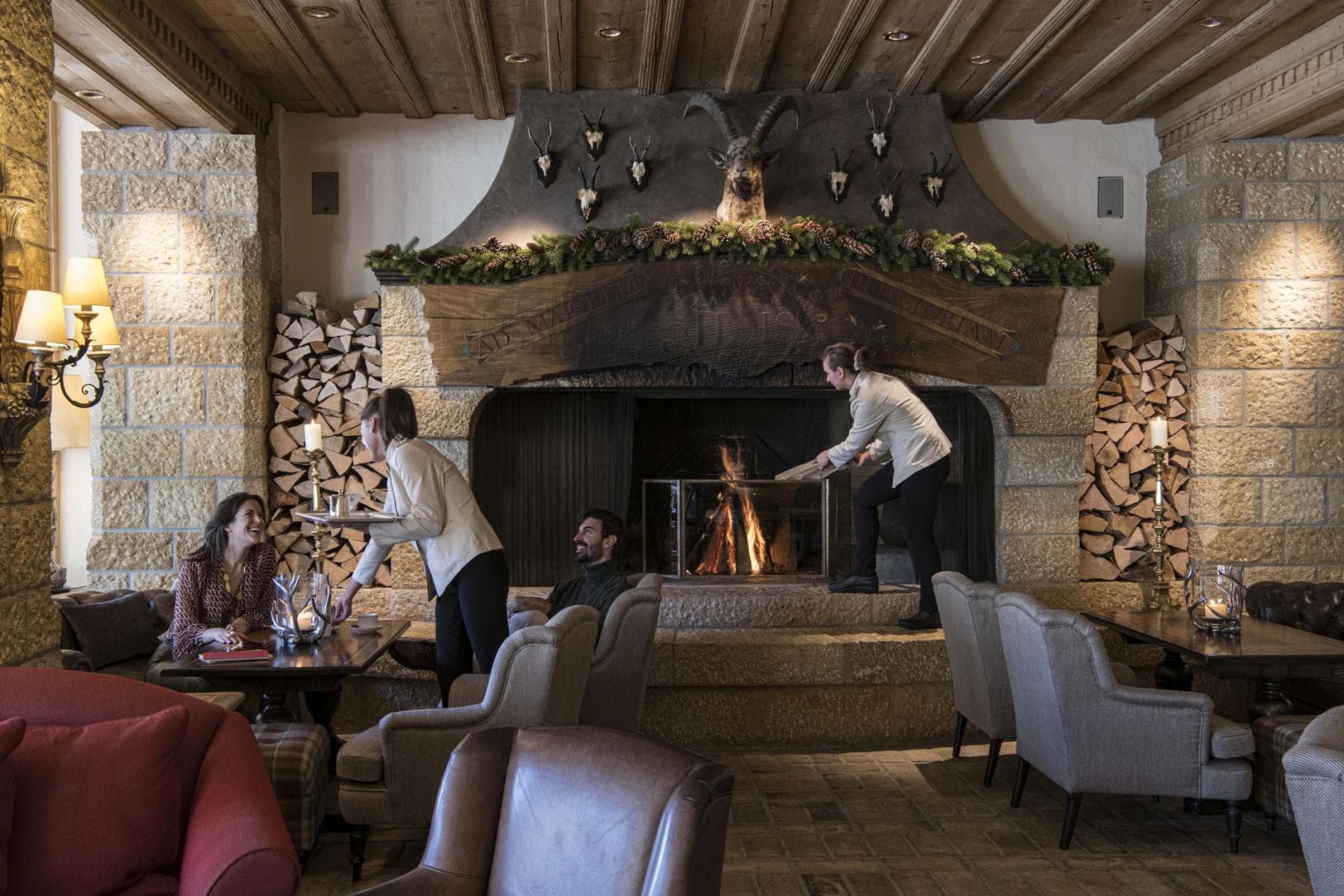 Lounge with wood-burning stone fireplace and full-service bar access