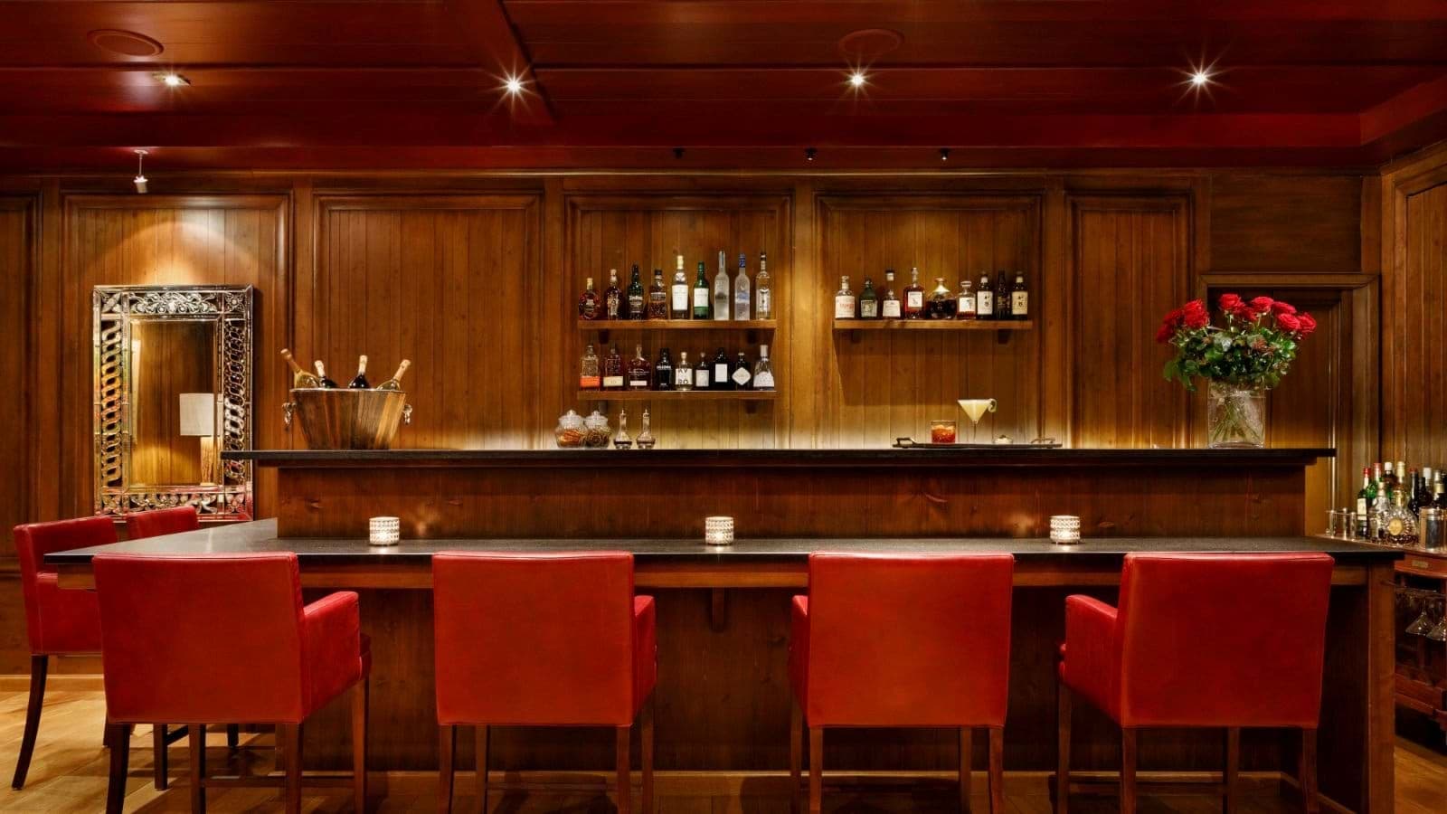 Wood-paneled cocktail bar with seating for 4 and integrated wine chiller