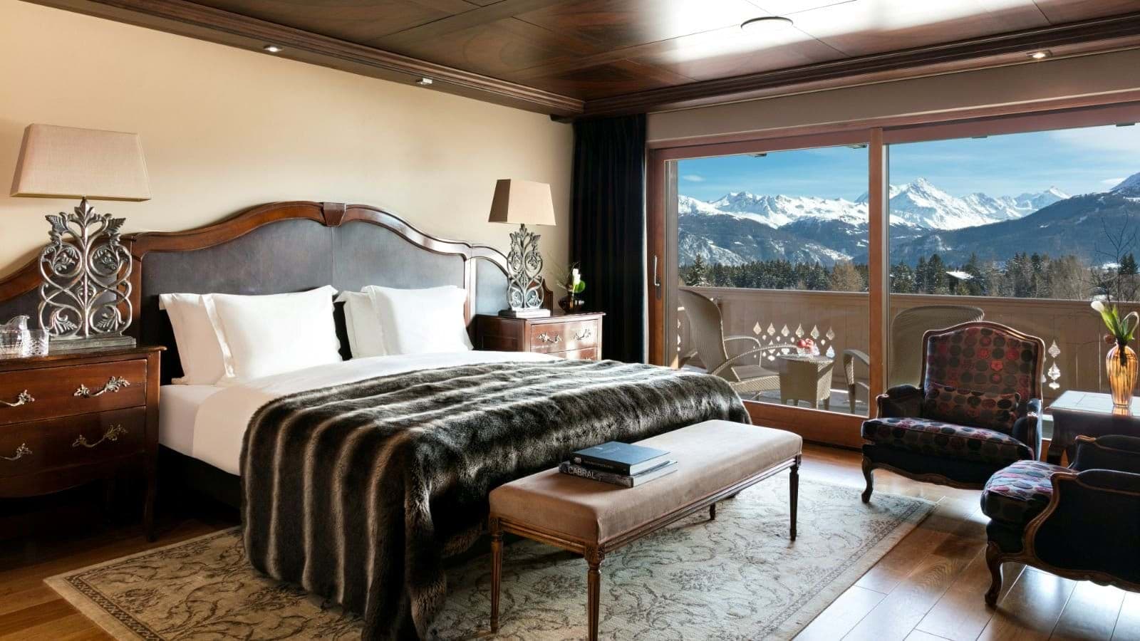 Primary bedroom with king bed and balcony access to mountain views