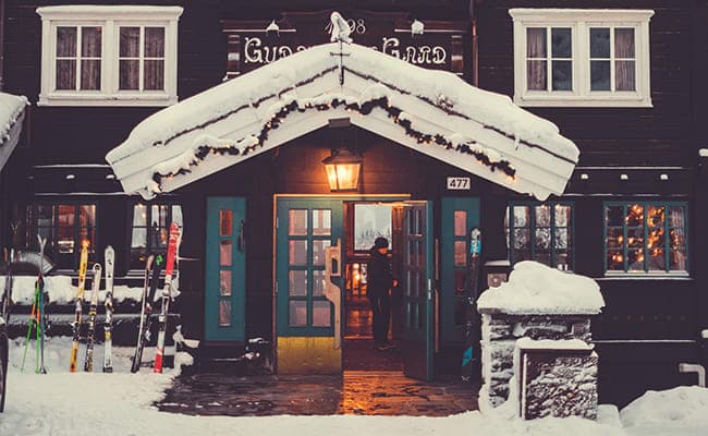 Ski-in entry with heated stone patio and exterior equipment storage