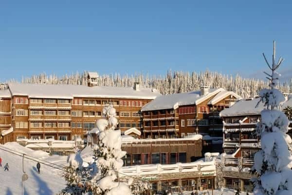 Ski-in, ski-out resort lodge exterior with direct access to groomed trails