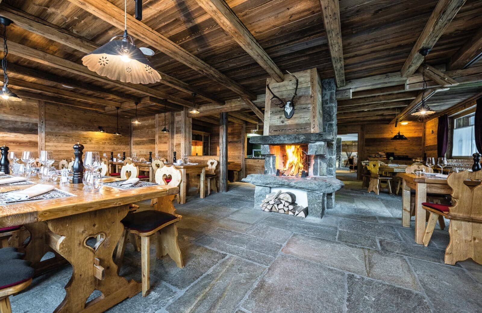 Dining room with wood-burning fireplace and natural stone flooring