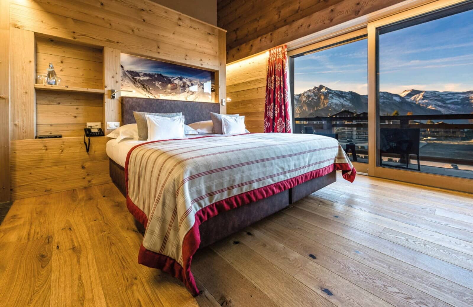 Primary bedroom with king bed and floor-to-ceiling mountain views
