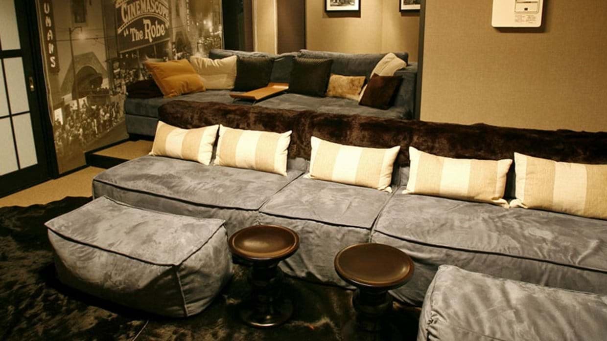 Media room with sunken sectional seating for 10+ and dual ottomans