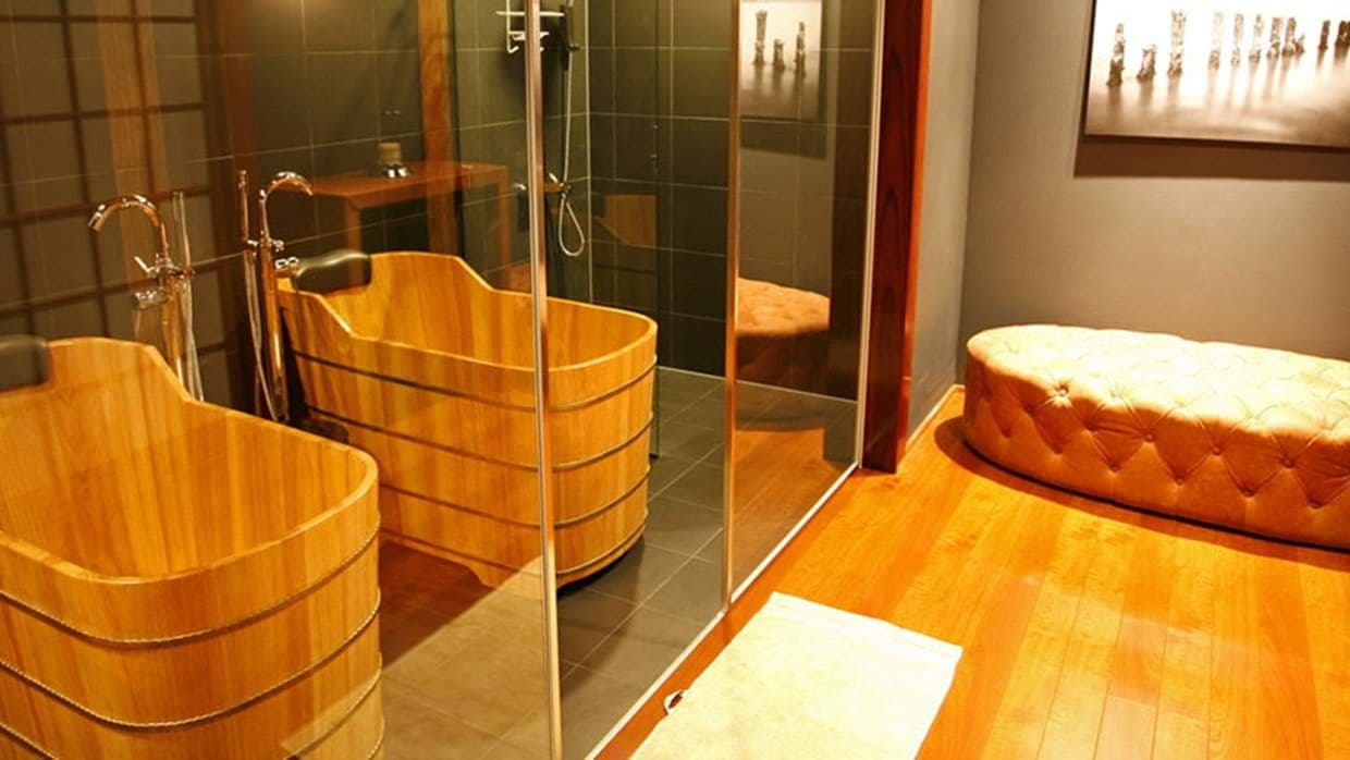 Spa bathroom with two wooden soaking tubs and walk-in shower