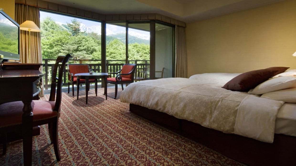 Guest bedroom with two twin beds and balcony access