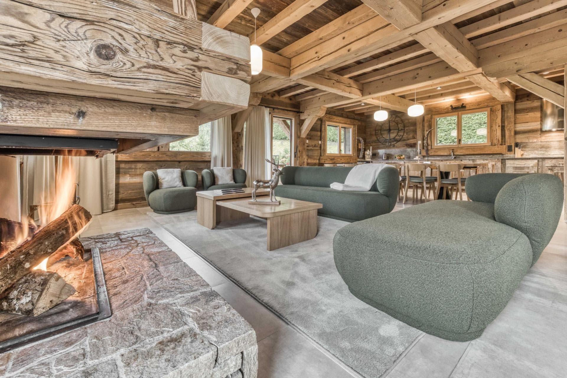 Open-plan living area with wood-burning fireplace and exposed timber beams
