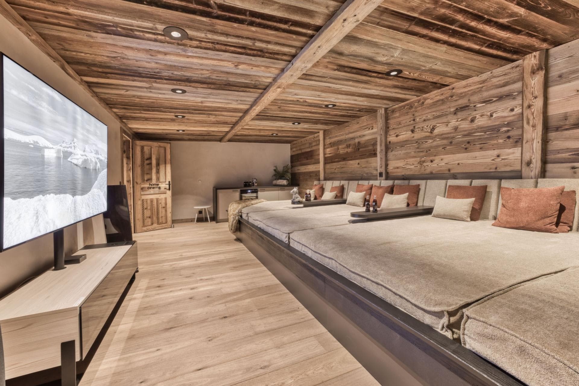 Media room with tiered daybed seating and kitchenette bar