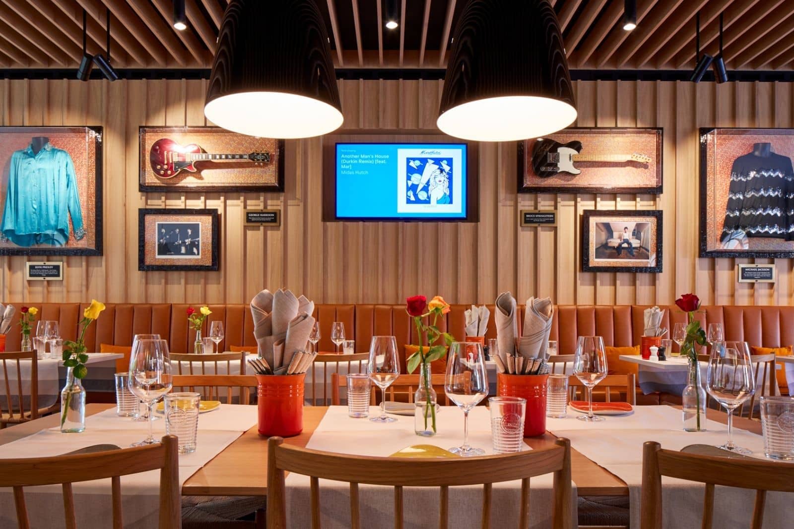Dining area with banquette seating and music memorabilia decor