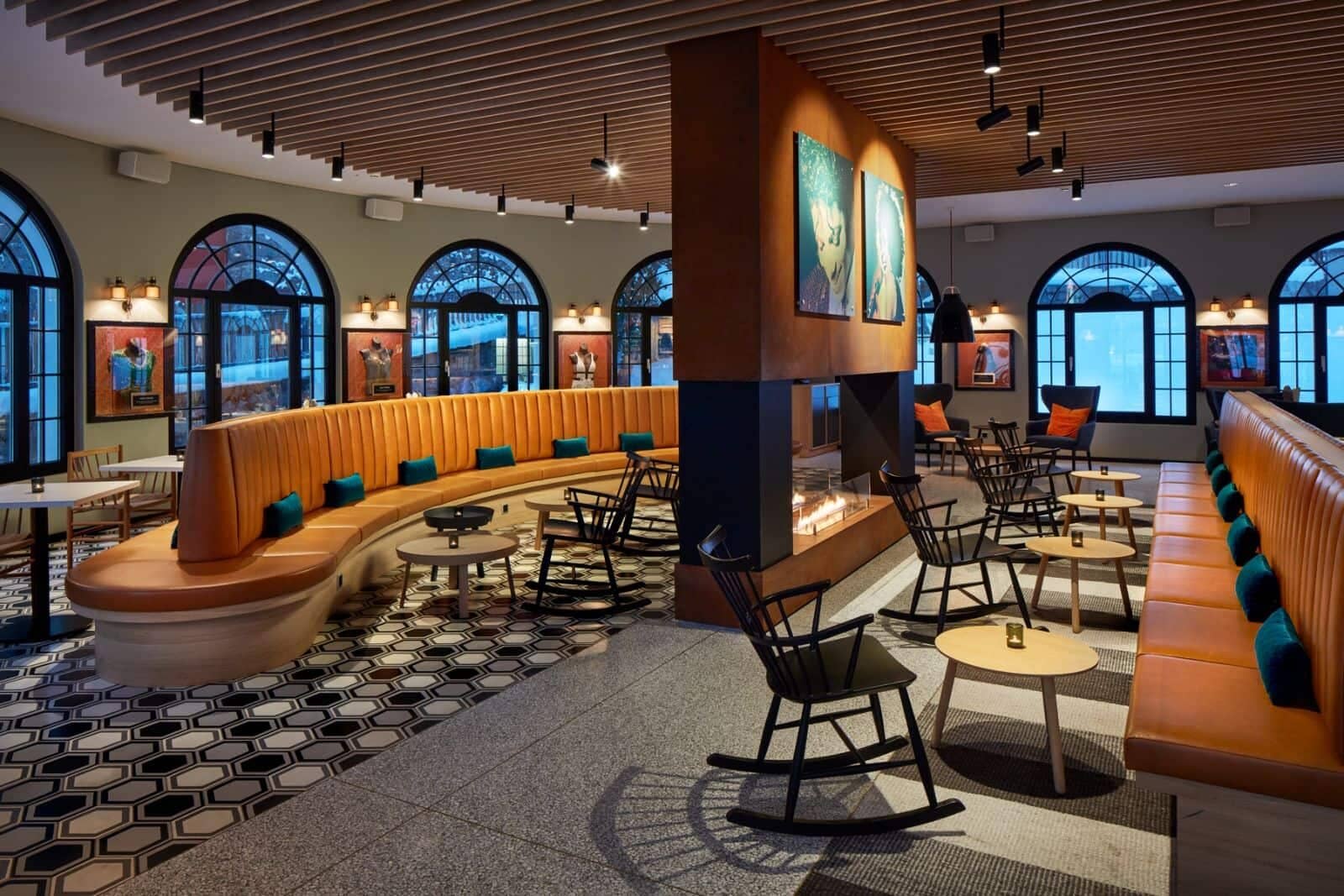 shared lounge with double-sided fireplace and curved banquette seating