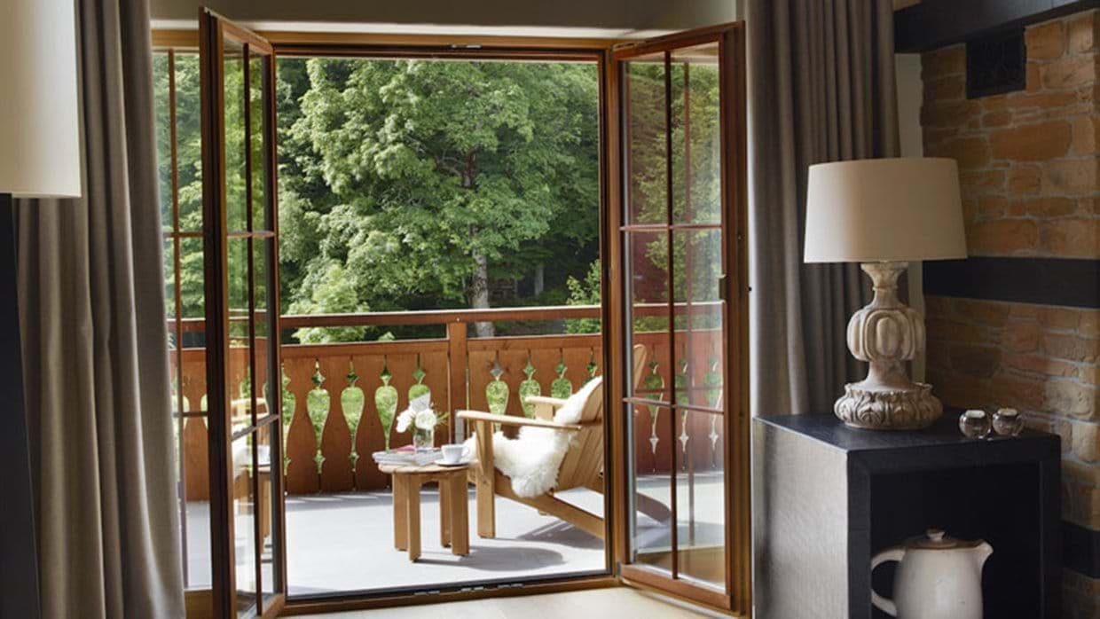 Private balcony with forest views and lounge seating