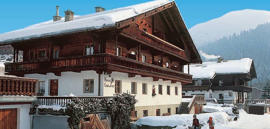 Alpine chalet with wraparound wooden balconies and mountain views