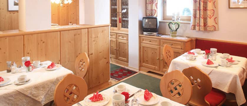 Breakfast room with individual table seating and traditional wood paneling