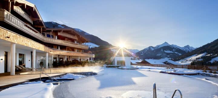 Heated outdoor pool with mountain views and covered deck seating