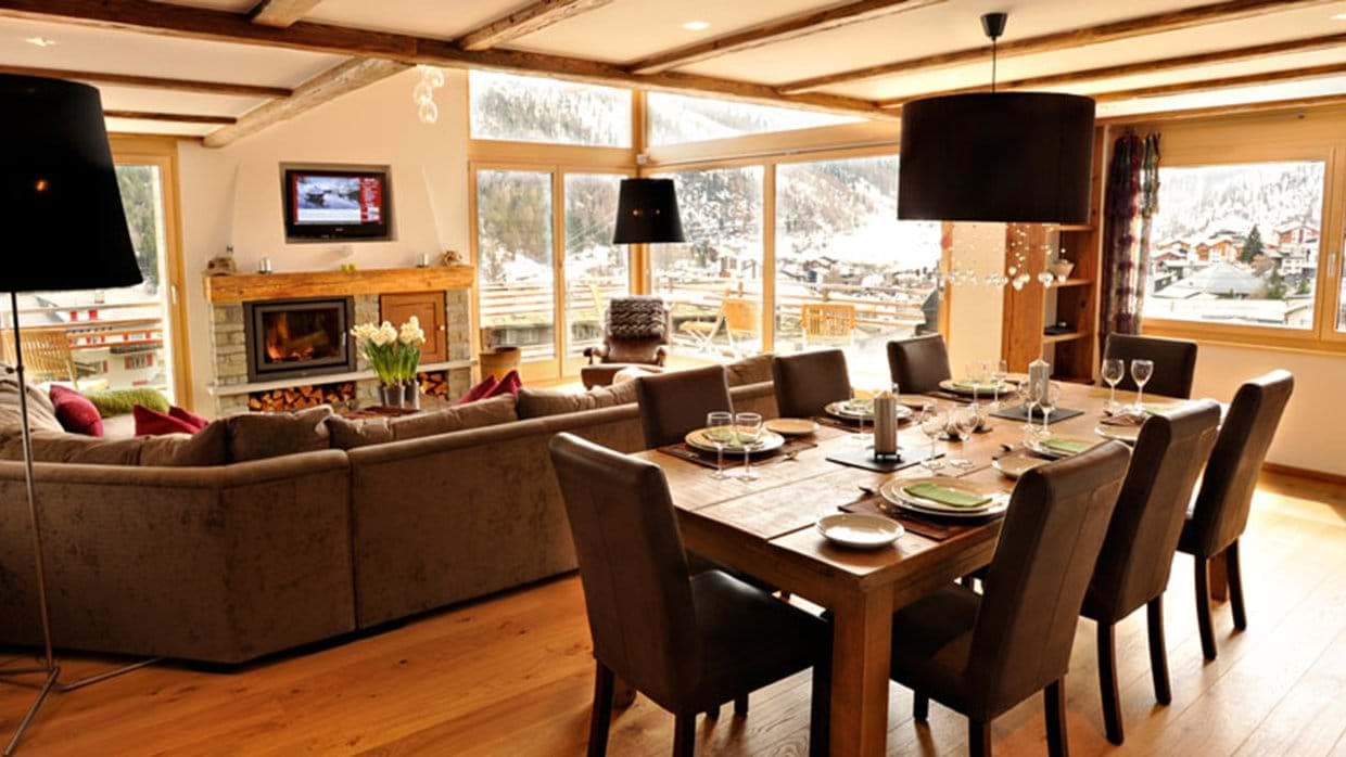 Open-plan dining area for 8 with wood-burning fireplace and village views