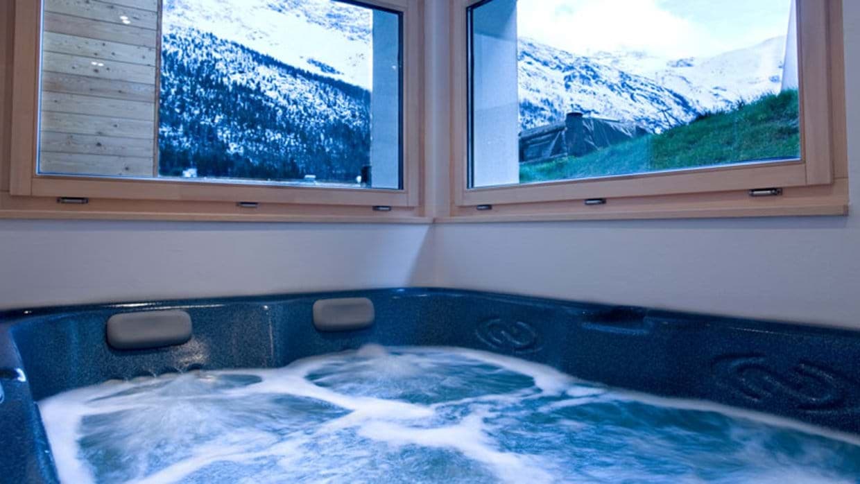 Indoor hot tub with views of snow-capped mountains