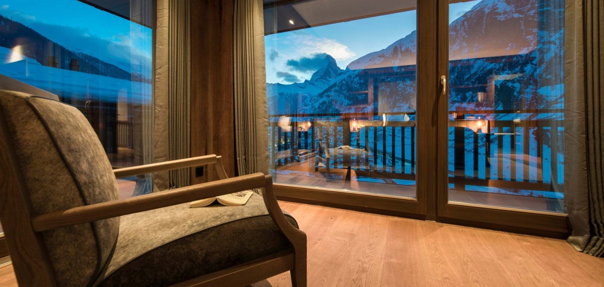 Floor-to-ceiling windows with Matterhorn views and private balcony access