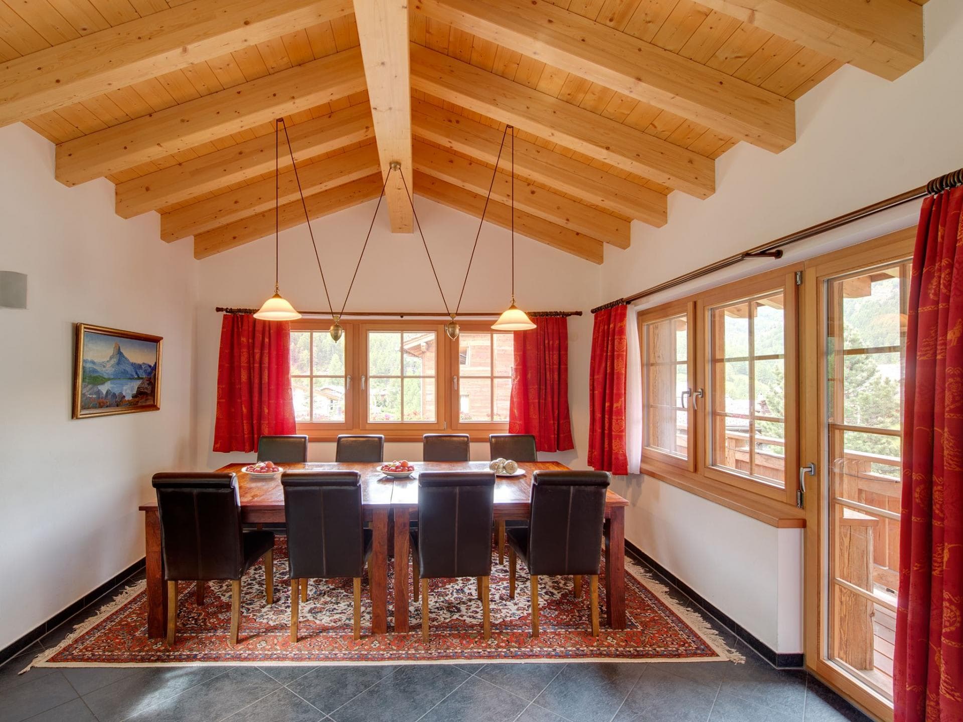 Dining area seats 8 under vaulted wood ceilings