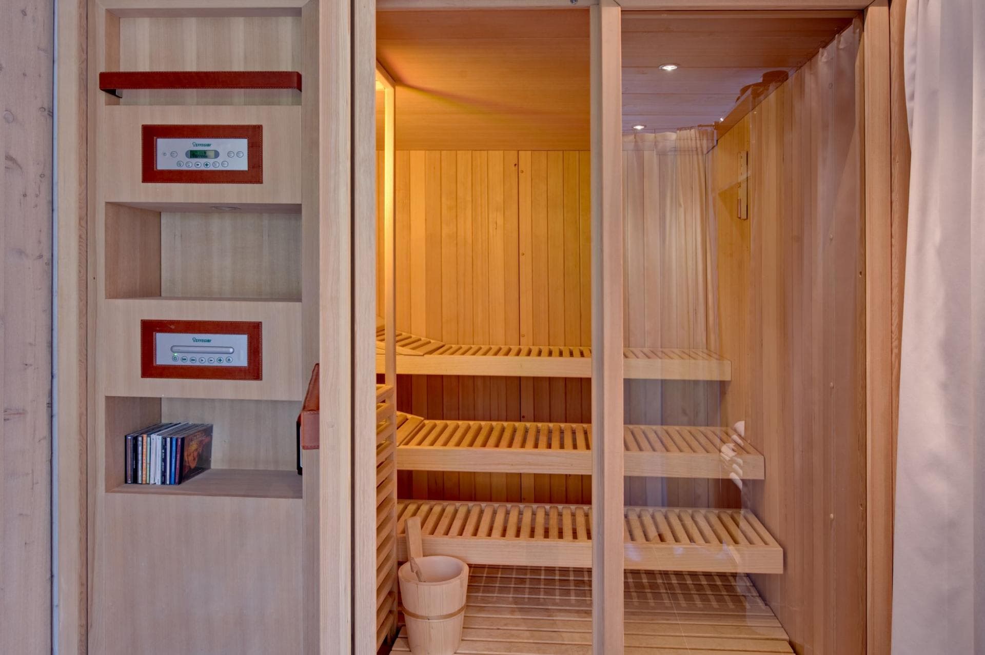Private sauna with tiered cedar seating and digital temperature controls