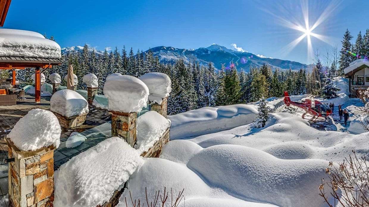 Stone patio with mountain views and private helicopter landing area