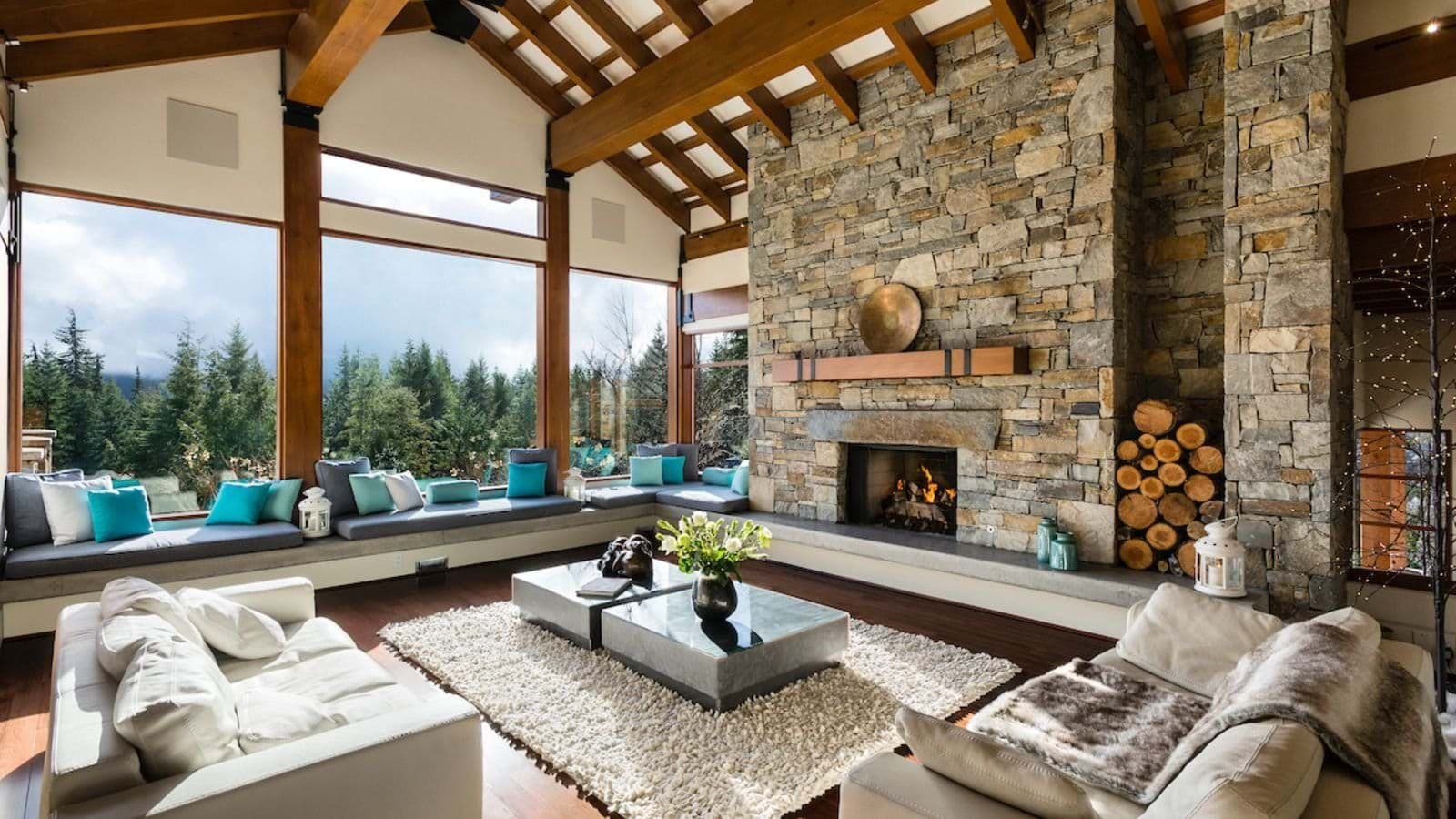 Living room with wood-burning fireplace and wrap-around window seating