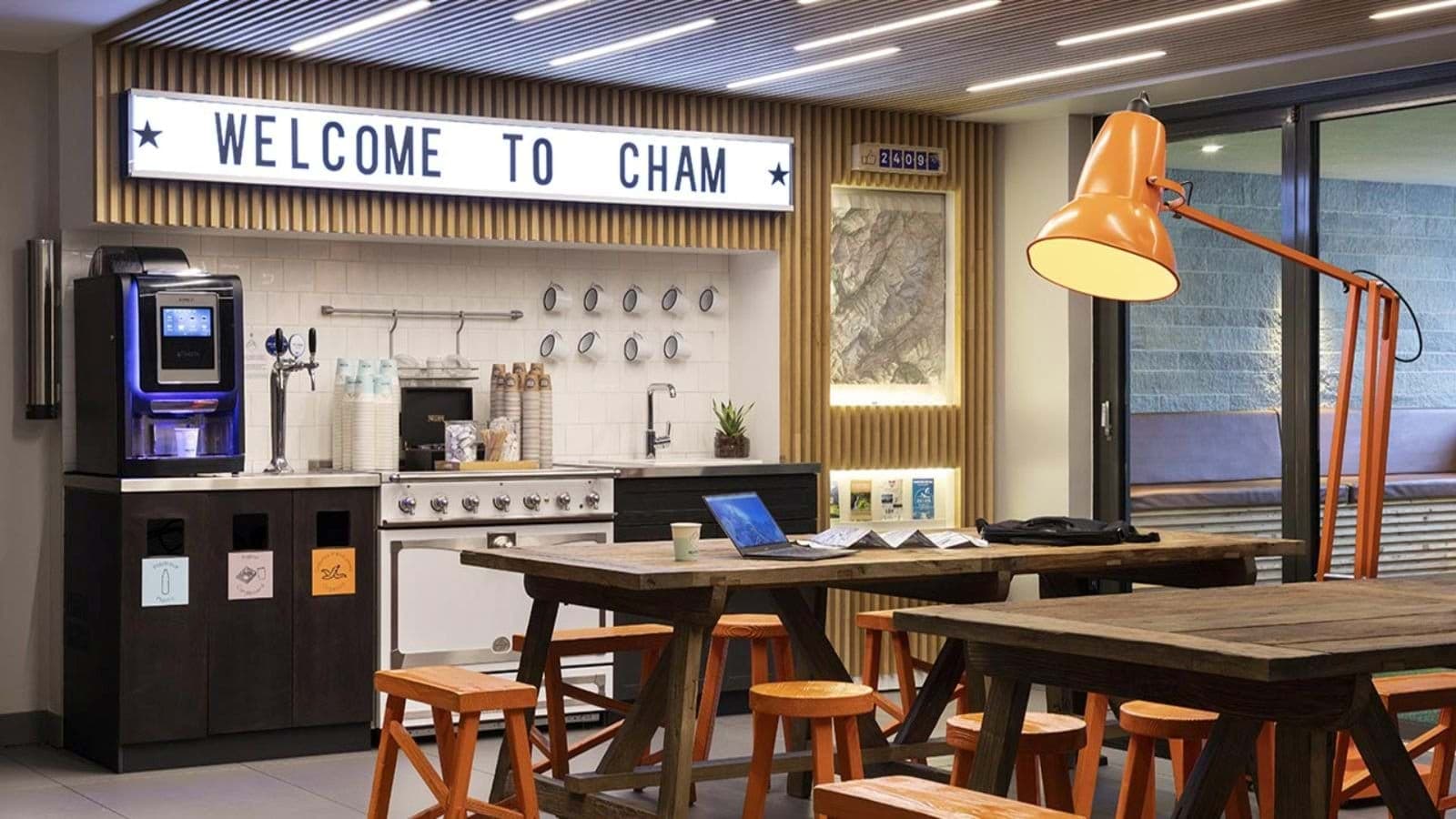 Shared kitchen and workspace with espresso machine and communal bench seating